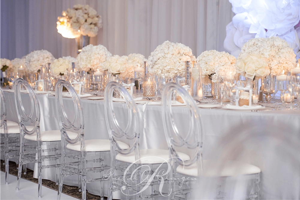 An Aisle Of White Rose Petals And Branches Dripping With Crystals