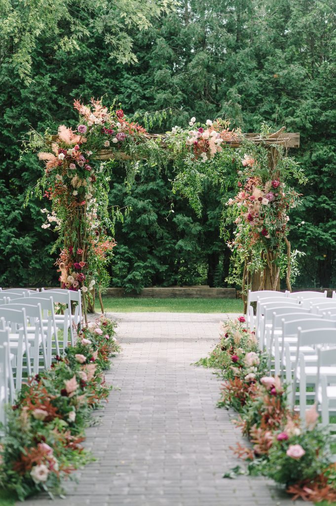 dusty rose wedding flowers arch
