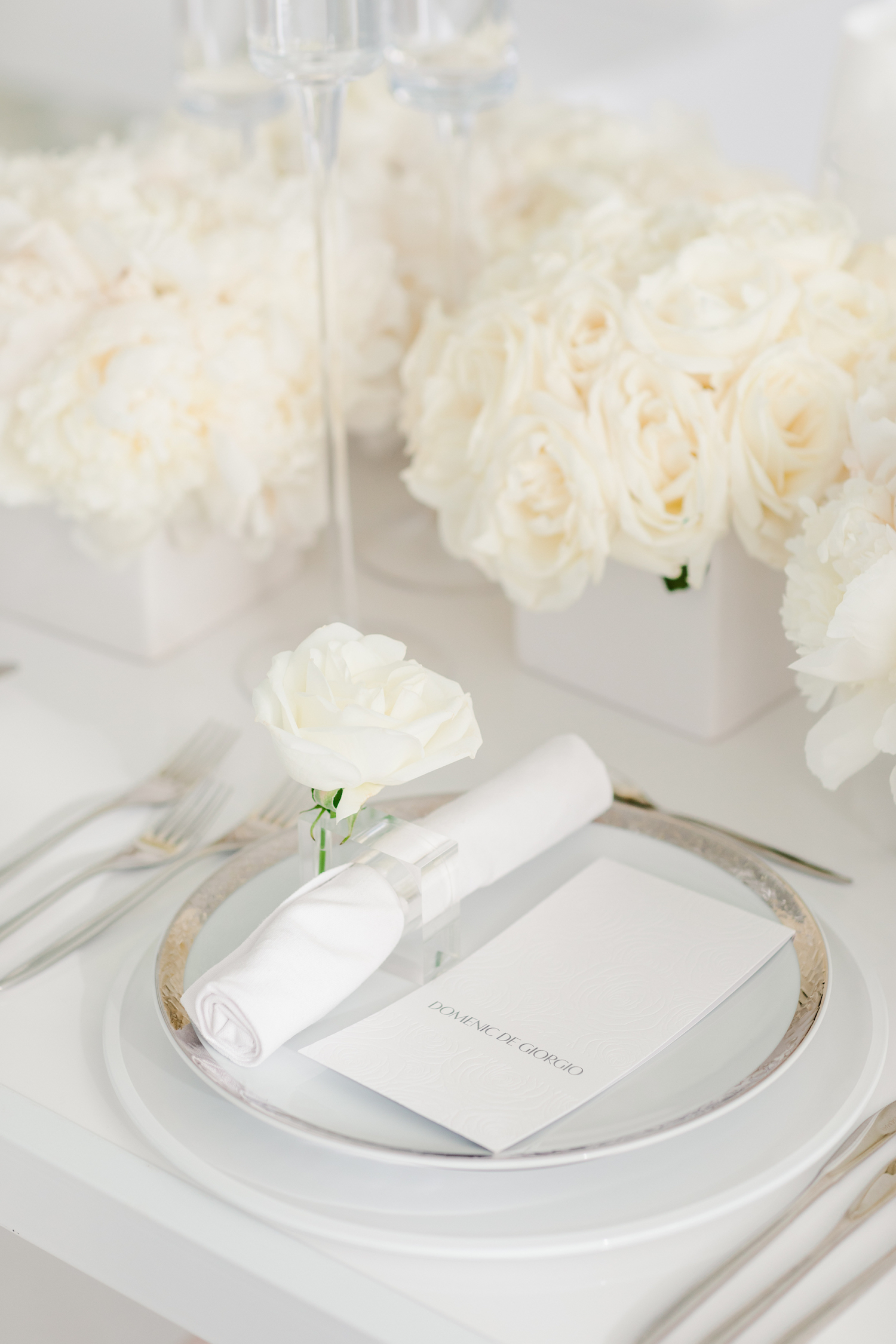 all white luxury wedding placesetting